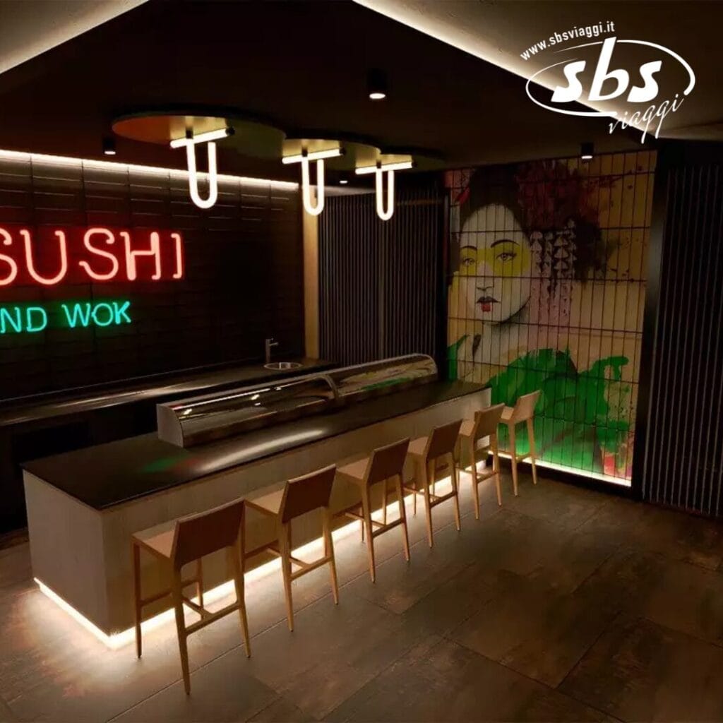 Un moderno ristorante di sushi con un lungo bancone, sgabelli da bar e un'insegna al neon
